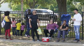  People wait outside the Orlando Immigration and Customs Enforcement facility in order to get appointments with federal immigration officials, Monday, May 2, 2022, in Orlando, Fla. As many as 250 people have been waiting each day outside the ICE facility for an appointment with immigration officials, sometimes sleeping in cars and tents while they bide their time. 