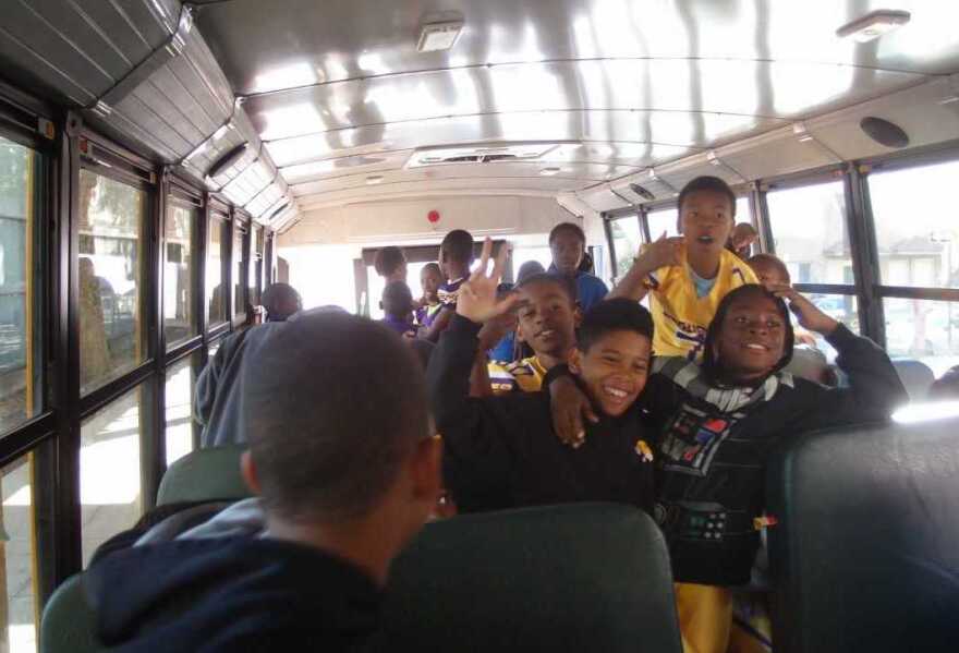 Kids on the Mo Better Jaguars football team board a bus in Brownsville, Brooklyn to go to a game in September 2014.