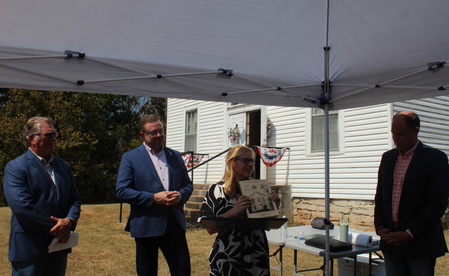 Amy Westermann holds minutes from Cave Spring Memorial Church and talks about its history as Greene County Commissioners Russell MacLachlan, Bob Dixon and John Russell watch during a rededication on September 8, 2026.