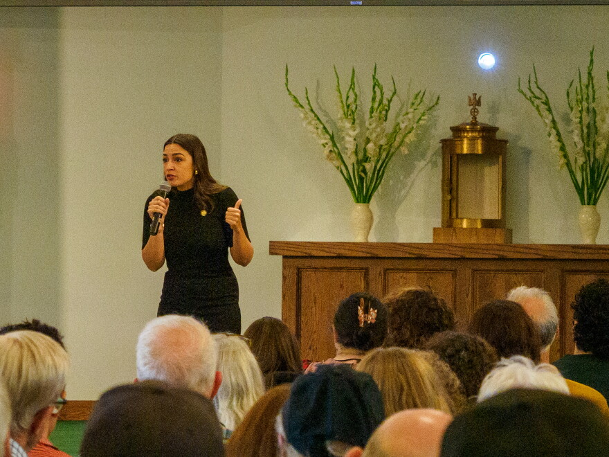Rep. Alexandria Ocasio-Cortez speaks to a crowd at All Saints Catholic Church.