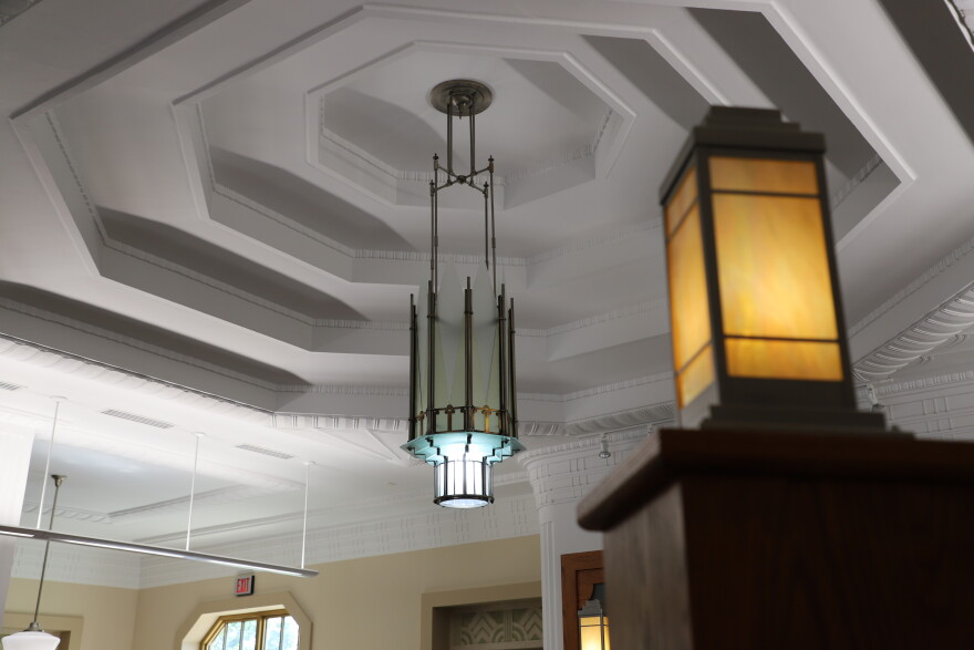 The original chandelier from the terminal lobby hangs in the center of the drop ceiling on the first floor. Theken had the lamp taken down and rebuilt before reinstalling it in its original spot. The light is one of two original to the building.