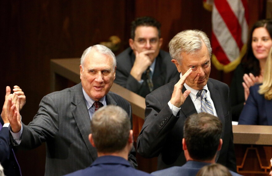 Former Arizona Republican Sen. Jon Kyl, left, and Bruce Babbitt, right, former Arizona Democratic governor and secretary of the Interior, wave to the crowd as they are recognized during Arizona Gov. Doug Ducey's state of the state address on Jan. 14, 2019, in Phoenix.