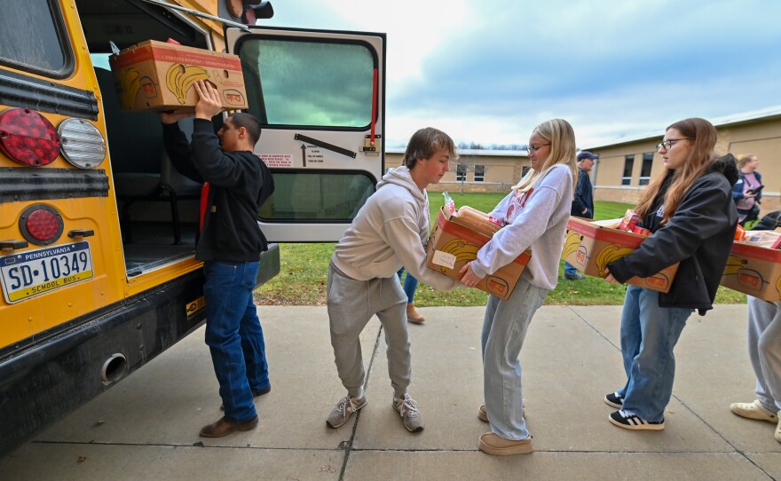Forest City Regional High School students fill one of two buses to deliver food in the community.