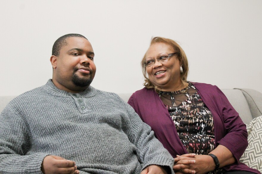 Edward Lofton and his mom, Joanna sitting on a grey sofa