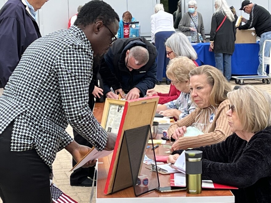 Volunteers from the League of Women Voters assist the new citizens with getting registered to vote in the upcoming elections.