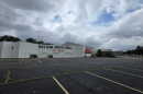 A large building with the words Western Sports Mall in front of a large parking lot.