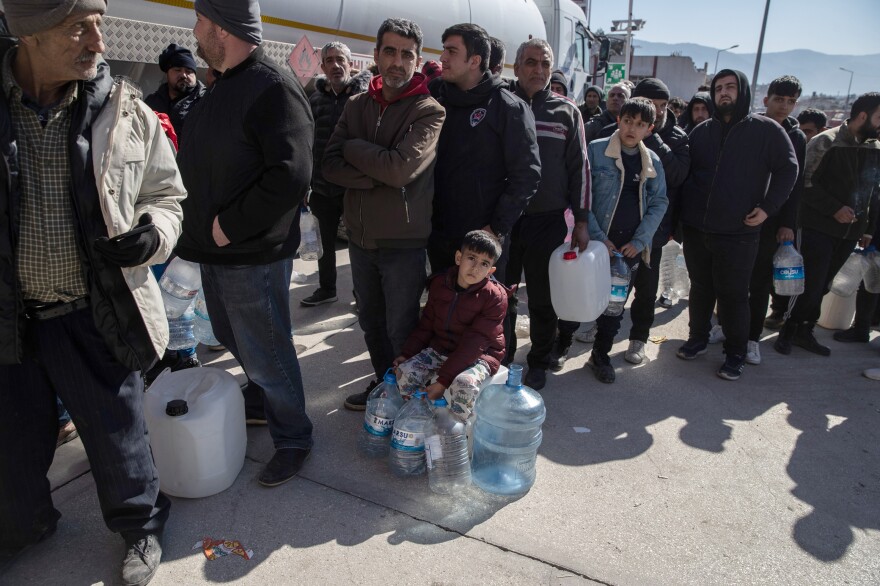 People wait in line for clean water in Hatay, Turkey on Thursday.