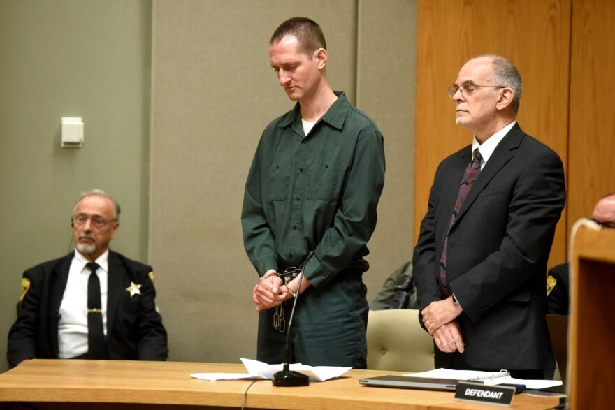 Robert Tulloch listens as Judge Lawrence MacLeod reads out his new sentence during a hearing July 13, 2026, in Grafton Superior Court in North Haverhill, N.H. At right is Tulloch's lawyer, Richard Guerriero. Tulloch pleaded guilty of murdering two Dartmouth College professors as a teenager more than 25 years ago. (Valley News photo / GSNC)