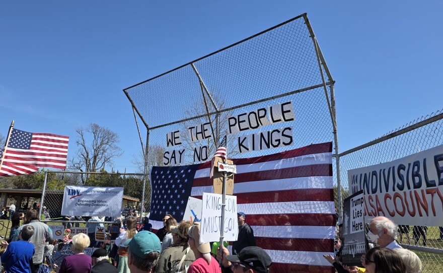 Hanging signs reading "WE THE PEOPLE SAY NO KINGS" at Tulsa's third "No Kings" rally on March 28, 2026.