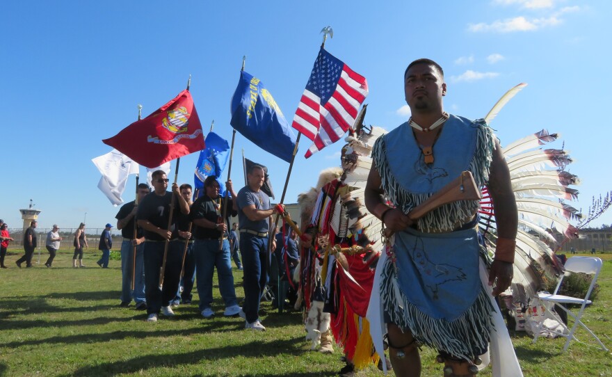 Powwow dancers and flag bearers. 