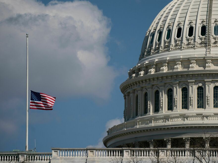 The U.S. flag flies at half mast outside the U.S. Capitol on Wednesday.