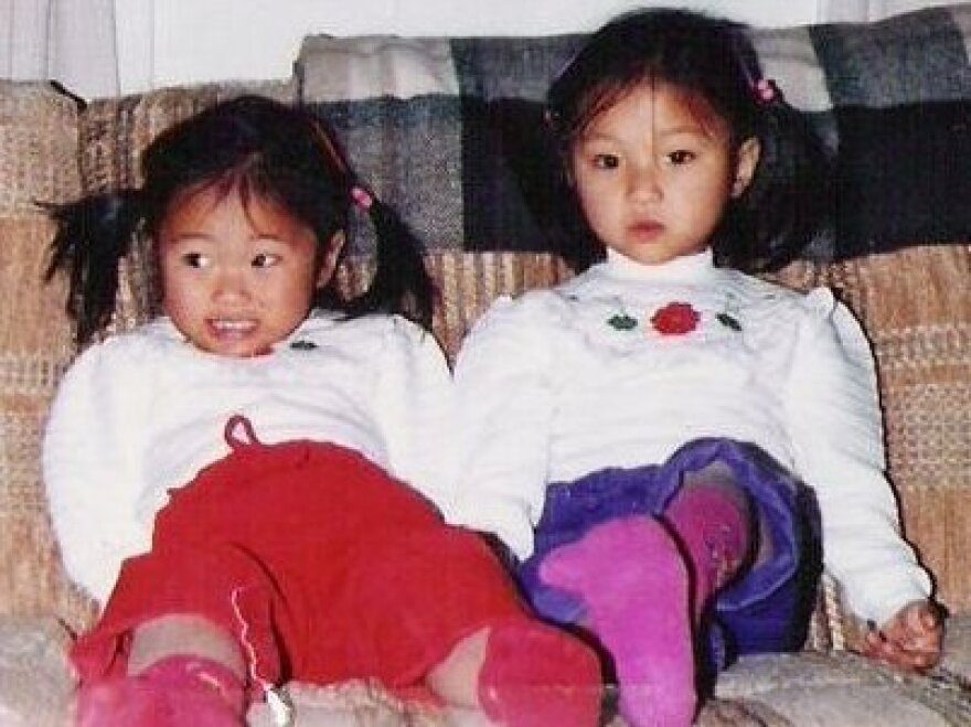 Shannon Heit (right) with her twin sister at age 4, near the time they were adopted and taken to the United States.