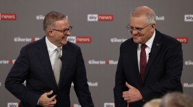 Australian Prime Minister Scott Morrison, right, and leader of the Labour Party Anthony Albanese, left, share a laugh during a debate in Brisbane, Wednesday, April 20, 2022. Australia will have a national election on May 21. (Jason Edwards/Pool Photo via AP)