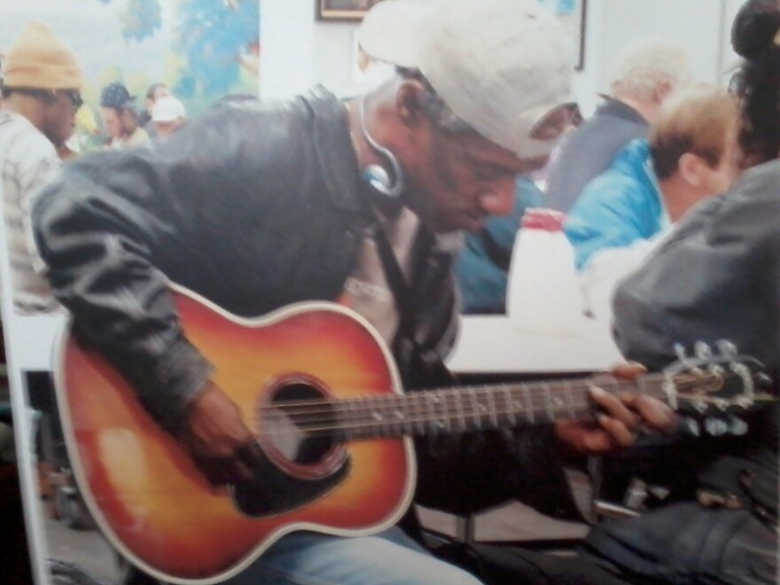 In his family's only photo of him, Bobby Clark plays guitar at the homeless shelter he frequented. Clark often played for shelter patrons and staff.