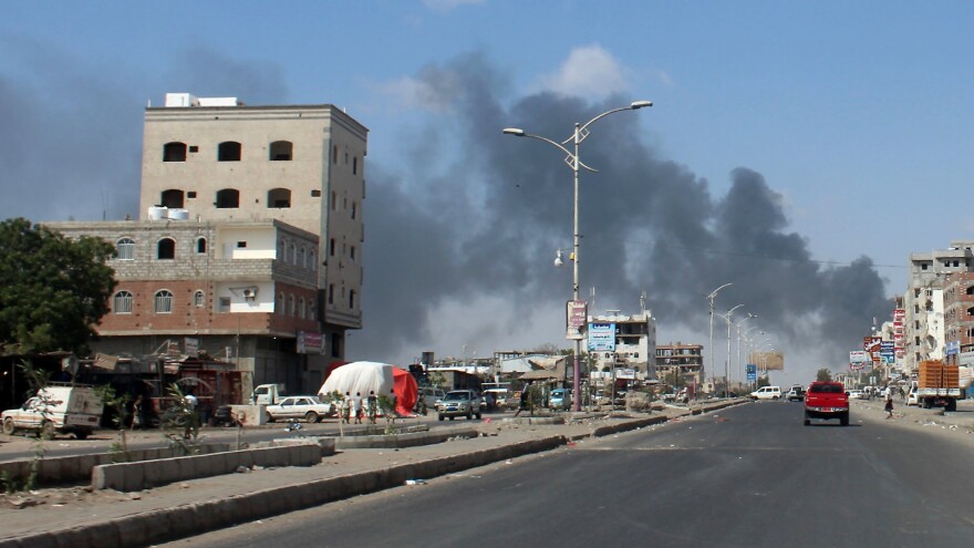 Smoke reaches skyward Tuesday in Aden, the Yemeni government's de facto capital. Since clashes began between government forces and southern separatists Sunday, several dozen people have died and dozens more have been injured.