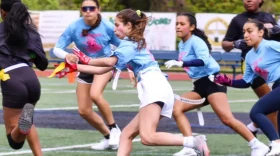 Olivia Iafrate (center) competes for Johnston High School in a girls' flag football game.