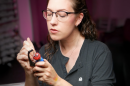 A woman paints a mini figurine