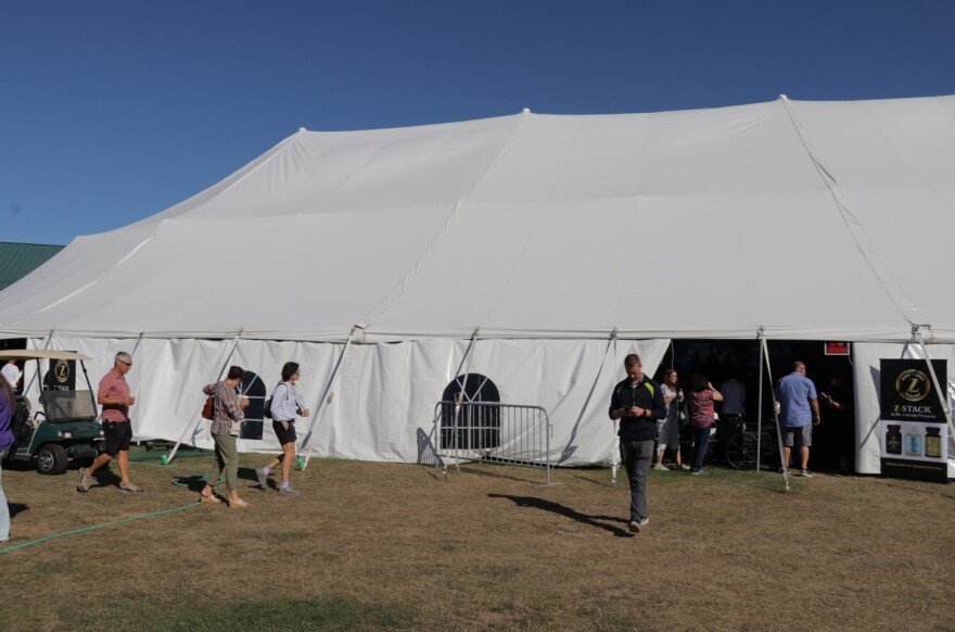 Attendees make their way and in and out of the revival tent at Cornerstone Church during the ReAwaken America Tour Aug. 12, 2022.