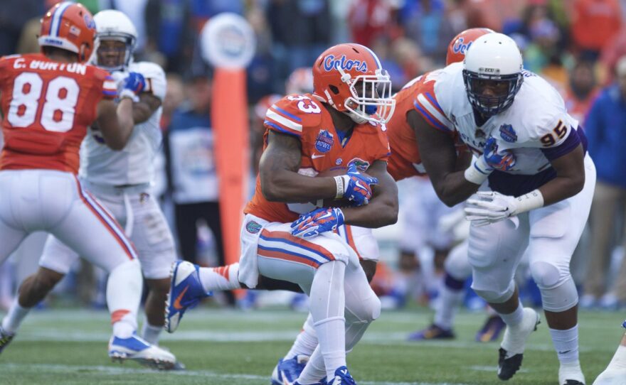 Florida running back Mack Brown cuts back to his left, while an ECU defender zeros in.