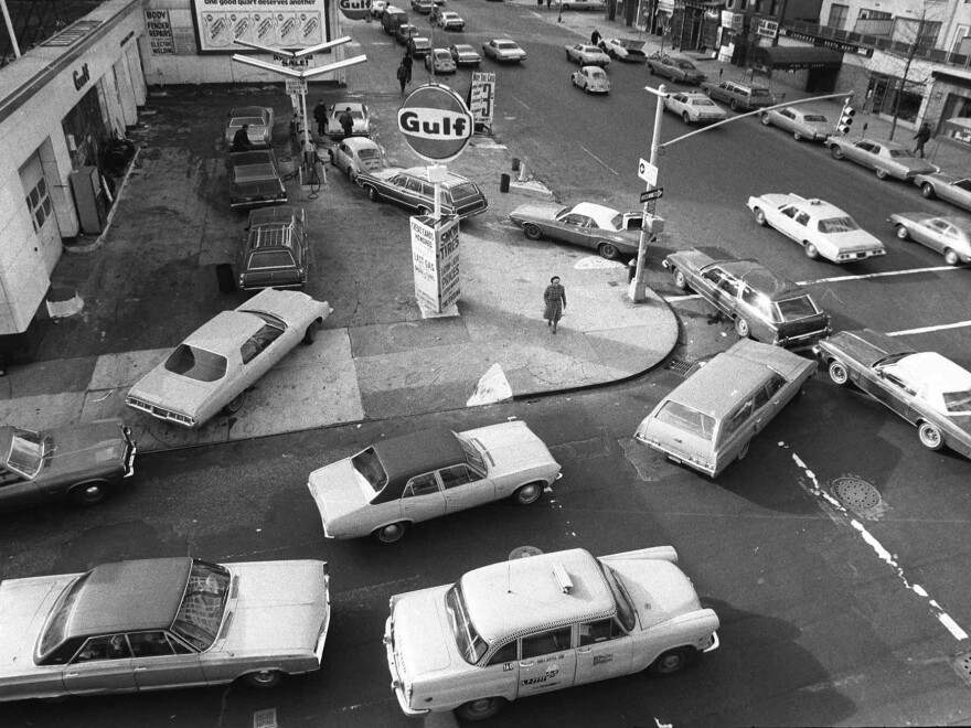 In this Dec. 23, 1973 file photo, cars line up in two directions at a gas station in New York City. The 1970s was a period defined by devastating double-digit inflation, requiring drastic action from the Federal Reserve.