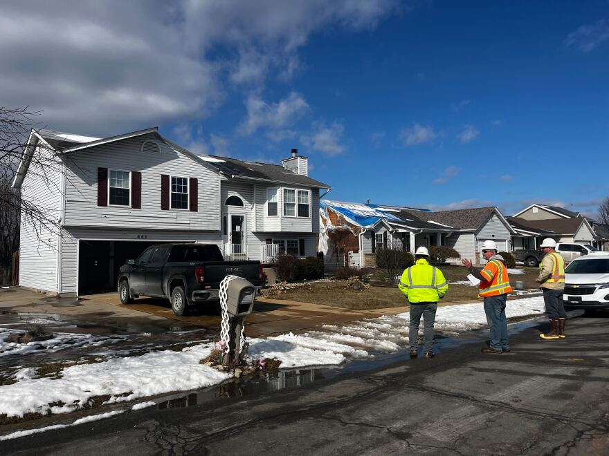 A group of workers stand outside one of the homes on Cades Court in Florissant that will be demolished next week. The U.S. Army Corps of Engineers is tearing down six homes to remediate nuclear contamination beneath the foundations.
