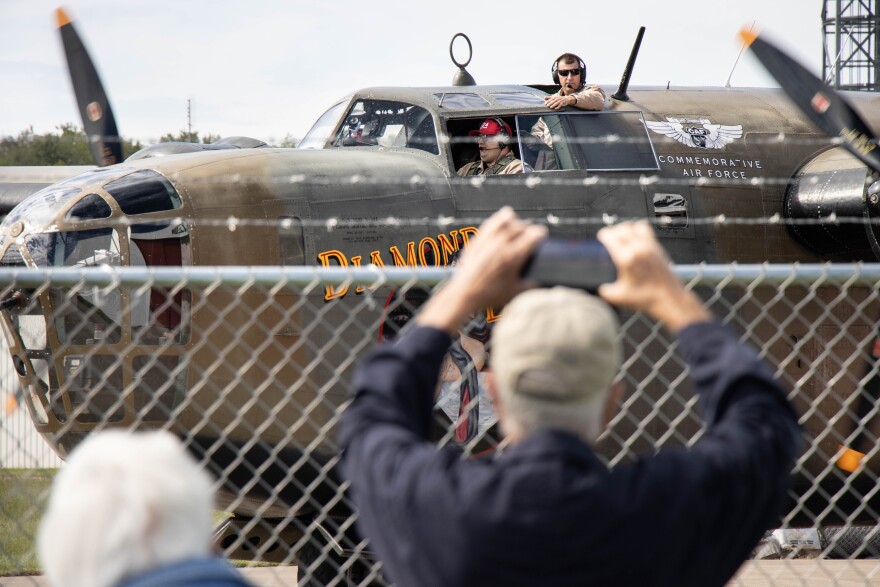 Visitors take photos of the B-24 bomber as it taxis up to the museum September 22.