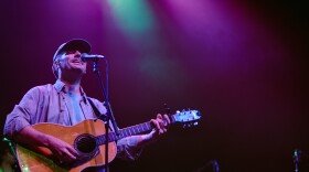 a man performing with an acoustic guitar