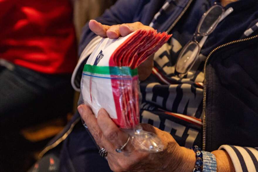 Maureen 'Moe' Buckley-Walsh hands out Patriots napkins to all of her friends on gameday watching at the Goat City Pub. If the team wins, she collects them and saves them to give out at the next Patriots game. If the team loses, everyone discards them. (Jesse Costa/WBUR)