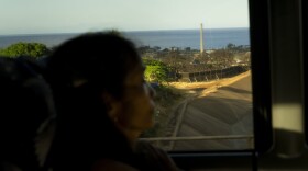 A commuter bus from Wailuku passes by Lahaina as Elsie Rosales travels across the island to her workplace on July 9, 2024. Rosales, who lost her home in Lahaina in the August 2023 wildfire, now lives in Kahului and gets up several hours earlier to make her commute, which includes an hour-long bus ride to Lahaina.