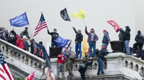 FILE - Rioters wave flags on the West Front of the U.S. Capitol in Washington on Jan. 6, 2021. Federal prosecutors are employing an unusual strategy to prove leaders of the far-right Proud Boys extremist group orchestrated a violent plot to keep President Joe Biden out of the White House, even though some of the defendants didn't carry out the violence themselves. AP Photo/Jose Luis Magana, File)