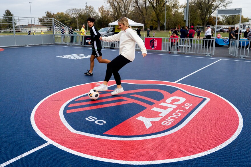 Ava Digirolamo, 16, of Collinsville, plays soccer with Mike Suarez, 15, of Fairmont City, on Thursday, Oct. 26, 2023, before the dedication of a St. Louis City SC mini pitch at Granby Park in Fairmont City.