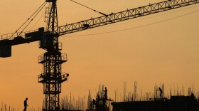 Workers construct an apartment building in Greater Noida, on the outskirts of New Delhi, India, Aug. 3, 2011. As many as 100,000 new apartment units are scheduled to be built on land that previously belonged to farmers. A court has halted some development on the grounds that the farmers weren't fairly compensated.