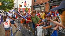 Fans line the street as the Grand Slam Parade passes by.