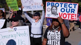 Voting rights activists gather outside the Supreme Court in Washington, early Wednesday, Oct. 15, 2025, as the justices prepare to take up a major Republican-led challenge to the Voting Rights Act, the centerpiece legislation of the Civil Rights Movement. (AP Photo/Cliff Owen)