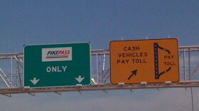 Signs on the Creek Turnpike telling motorists it is time to pay.