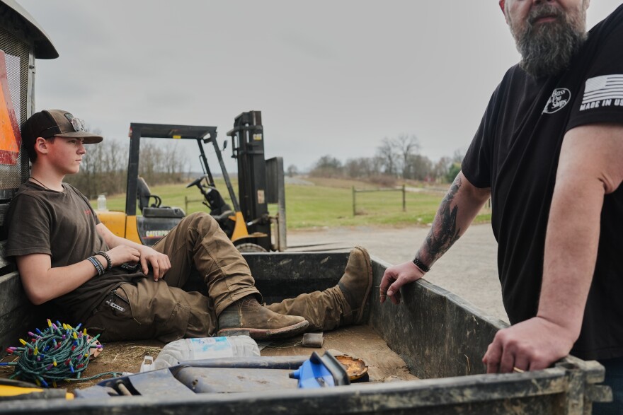 Blake Greier, 13, left, relaxes in the back of a farm vehicle Tuesday, March 10, 2026, in Canfield, Ohio.