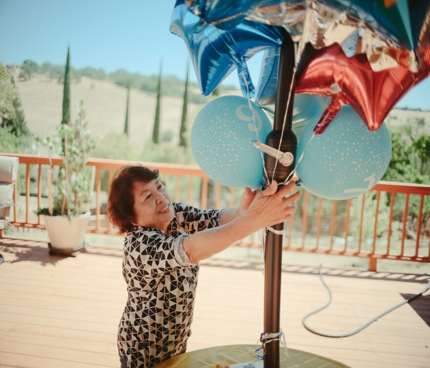 Perez, the owner of a small assisted-living facility in El Dorado, Calif., puts the finishing touches on preparations for a party for one of Hillcrest Care's residents on July 14, 2022, ahead of their 97th birthday celebration.