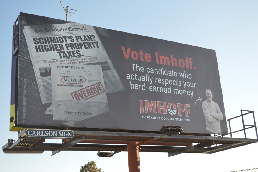 A billboard shown on Thursday, Oct. 8, 2026 stands on the northbound side off Business 97 in Bend, Ore. It depicts a fake newspaper and headlines alongside a real image of Deschutes County Commissioner candidate Rob Imhoff. The billboard discloses using AI.