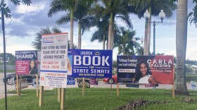 A Broward County sign at left informs voters they can't vote at this early voting library in Miramar, but many overlooked it and came anyways.