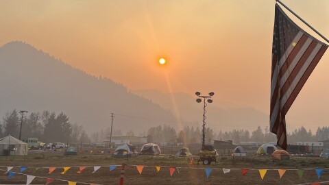Smoke lingers above the Cedar Creek Fire's West Zone Incident Command Post outside of Oakridge, Ore.
