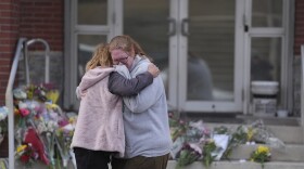 Leah Fauth gets a hug after leaving flowers in front of the West York Police Department after a police officer was killed responding to a shooting at UPMC Memorial Hospital in York, Pa. on Saturday, Feb. 22, 2025.