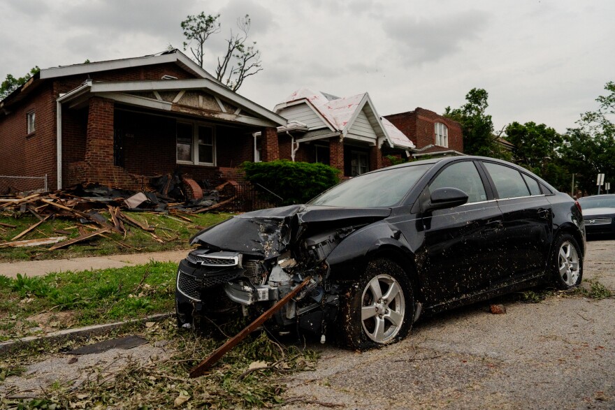 A damaged car and homes line San Francisco Avenue on Monday, May 19, 2025, in north St. Louis — days after an EF-3 tornado ripped through the city.