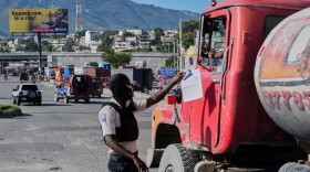 A police officer interacts with a truck driver as he patrols at an intersection in Port-au-Prince, Haiti, Tuesday, Sept. 29, 2026.