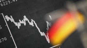 Frankfurt: A German flag hung today in front of a board displaying the DAX stock index.