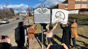 Roanoke school officials and community members unveil a state highway historical marker recognizing Lucy Addison.
