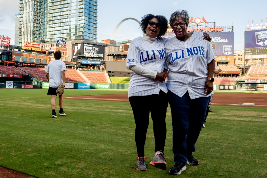 Illinois Sen. Adriane Johnson, D-Waukegan, embraces Illinois State Sen. Doris Turner, D-Springfield, on Monday, Aug. 7, 2023, during the 2023 Bi-State Softball Showdown at Busch Stadium.