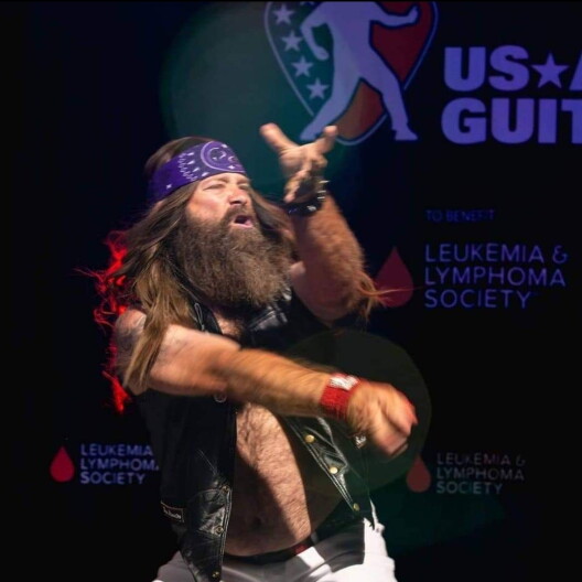 Brian "Fan Airnation" Dunn plays the air guitar.