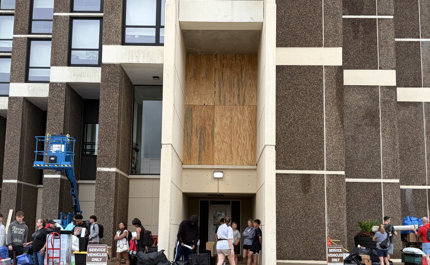 A damaged window at Illinois State University's Watterson Towers is seen boarded up Friday morning, Aug. 14, 2026.