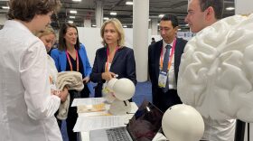 President of the Regional Council of Île-de-France, Valerie Pecresse (C), speaks with Emobot health tech co-founders.