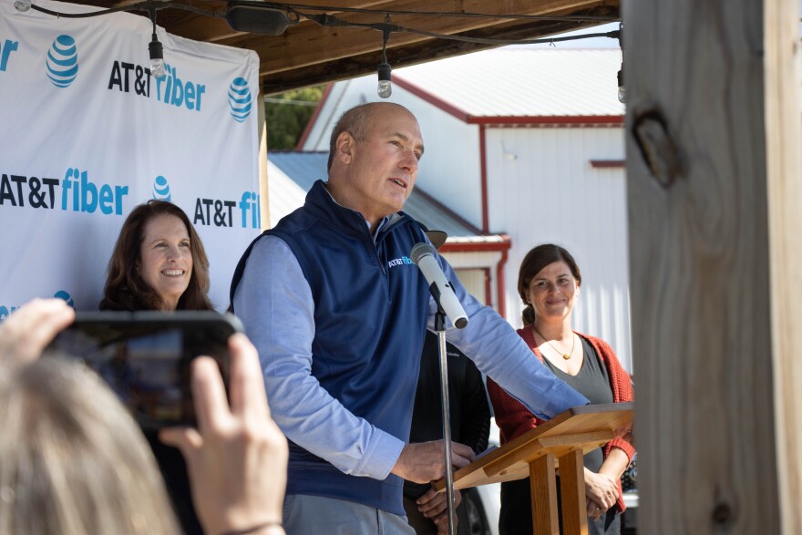 AT&T CEO John Stankey addresses the media and visitors to the event Wednesday at Farm 57 in Evansville. The event is celebrating the first 2,000 rural fiber access points coming online. Behind him on stage is Vanderburgh County Commissioner Cheryl Musgrave, who is instrumental in the project. On the right is Stephanie Peckenpaugh, co-owner of Farm 57, one of the first fiber internet customers.